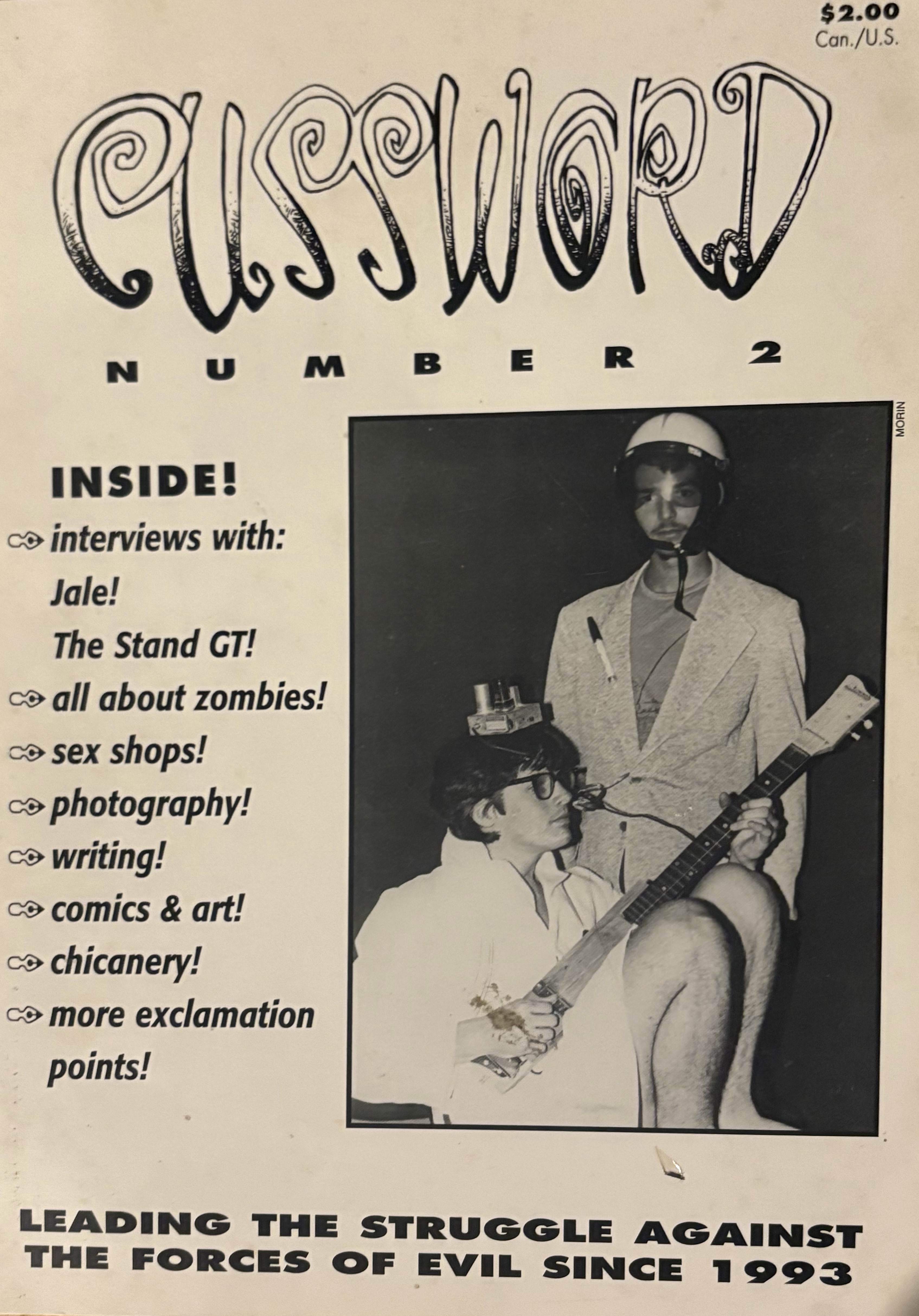 “Cussword Number 2” full-page zine, image of two men, one sitting with string instrument, one standing behind. Text describing content.